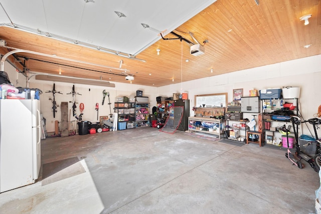garage with freestanding refrigerator and a garage door opener