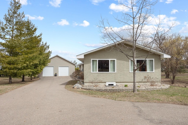 view of home's exterior featuring an outdoor structure and a detached garage