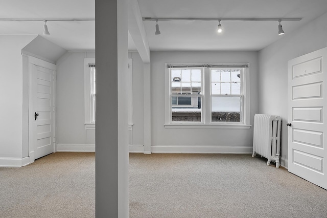 bonus room with carpet floors, radiator heating unit, and baseboards