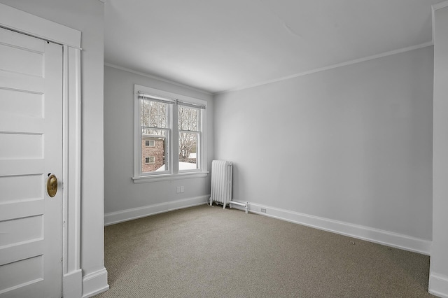 carpeted spare room featuring ornamental molding, radiator heating unit, and baseboards
