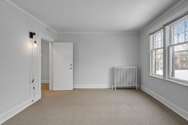 carpeted empty room featuring crown molding, radiator heating unit, and baseboards
