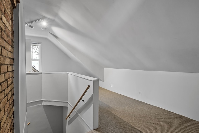 additional living space with lofted ceiling and carpet
