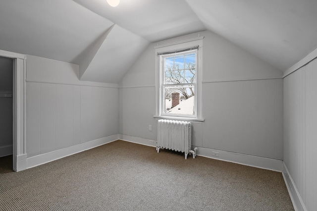bonus room featuring radiator, carpet flooring, and vaulted ceiling