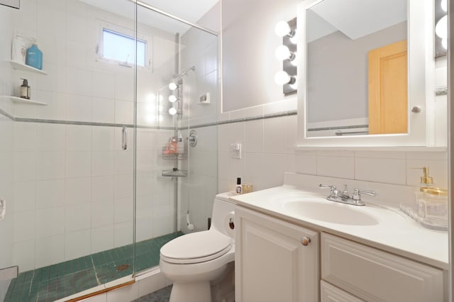 full bathroom featuring vanity, toilet, and a stall shower