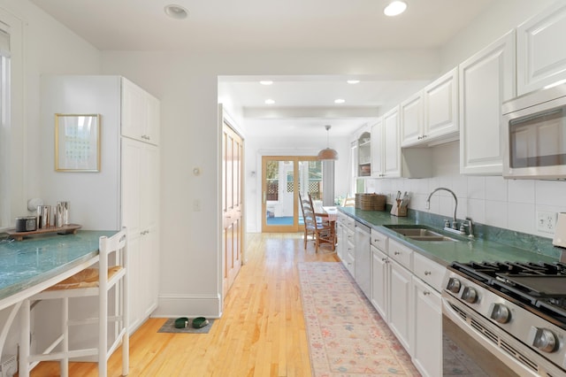 kitchen with white cabinets, appliances with stainless steel finishes, and a sink