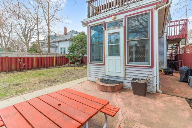 view of patio / terrace featuring area for grilling, a fenced backyard, and a balcony