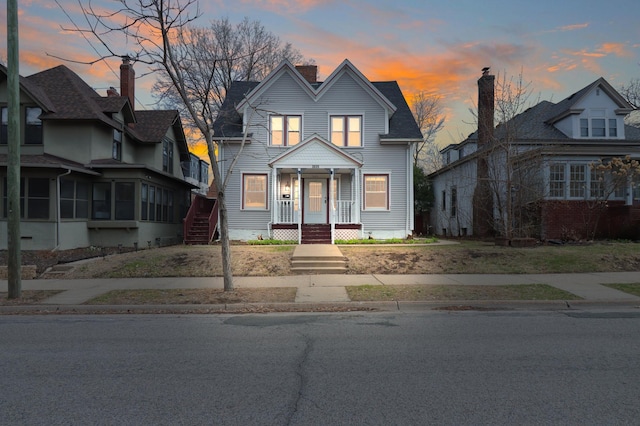 view of front of home featuring a porch and a chimney
