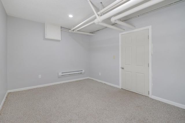 finished basement featuring a baseboard radiator, carpet, baseboards, and recessed lighting