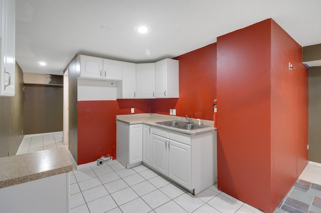 kitchen with white cabinets, a sink, recessed lighting, and light tile patterned floors