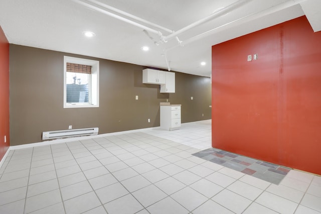 empty room with a baseboard radiator, light tile patterned flooring, and recessed lighting