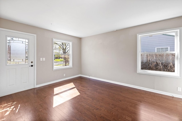 entryway featuring baseboards and dark wood-style flooring