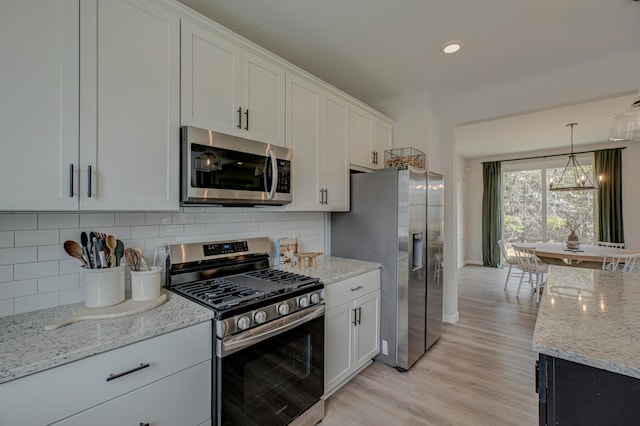 11422 34th St N, Lake Elmo, MN 55042 - kitchen featuring appliances with stainless steel finishes, light wood-type flooring, decorative backsplash, white cabinets, and light stone counters