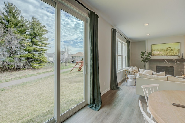 11422 34th St N, Lake Elmo, MN 55042 - dining area featuring a glass covered fireplace, wood finished floors, baseboards, and recessed lighting
