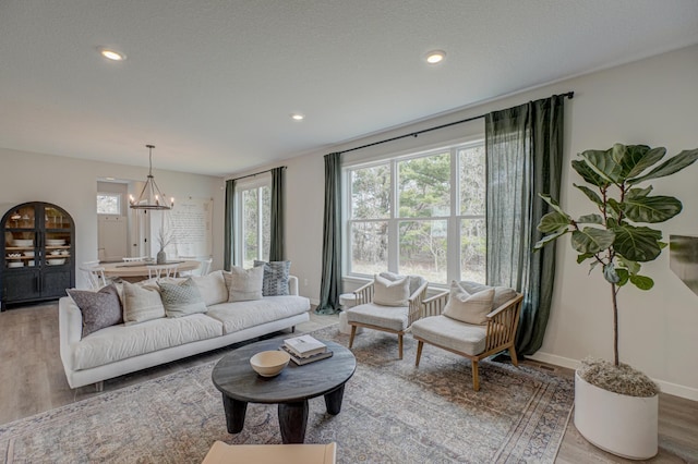 11422 34th St N, Lake Elmo, MN 55042 - living room featuring light wood-type flooring, a chandelier, baseboards, and recessed lighting