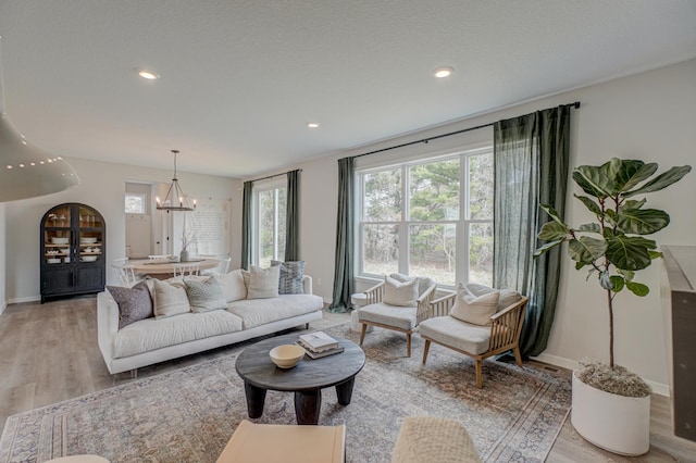 11422 34th St N, Lake Elmo, MN 55042 - living room featuring a chandelier, light wood-style floors, baseboards, and recessed lighting