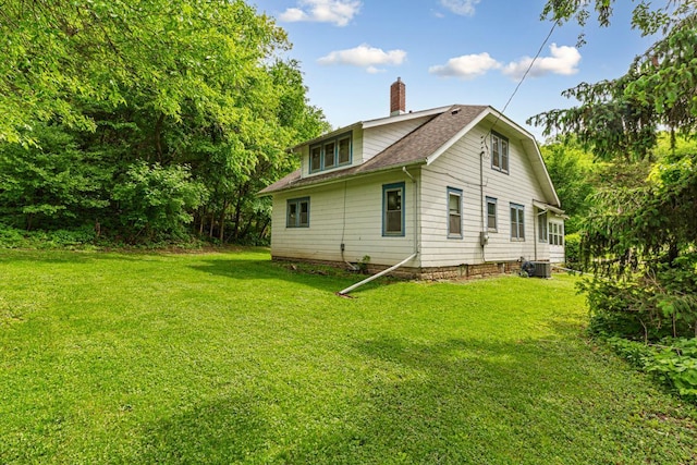 32673 Rosewood Ln, Saint Peter, MN 56082 - rear view of property with a chimney, cooling unit, a lawn, and a shingled roof