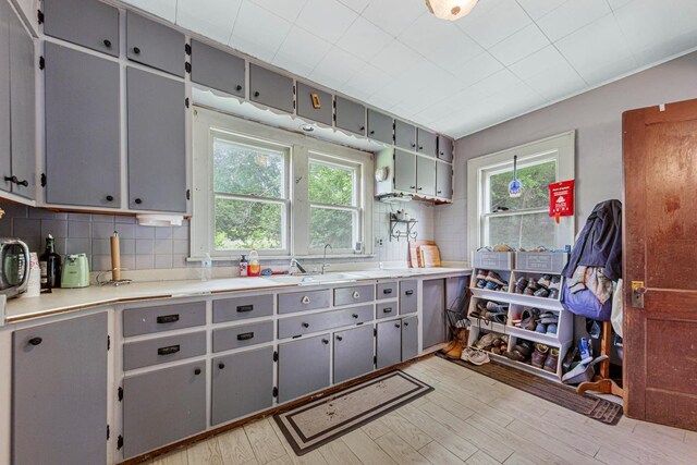 32673 Rosewood Ln, Saint Peter, MN 56082 - kitchen with a sink, gray cabinetry, and backsplash