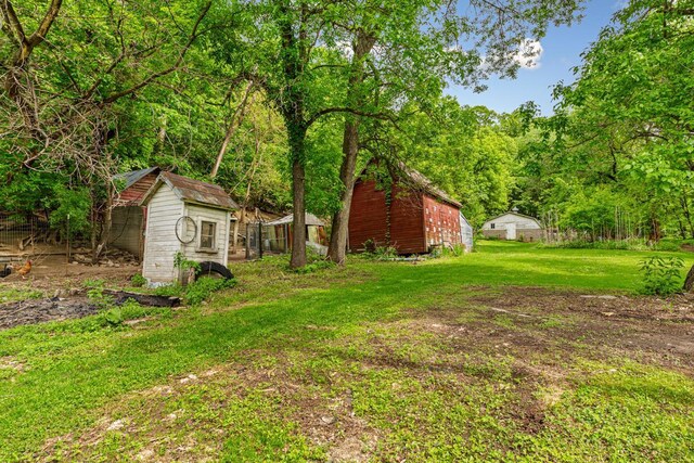 32673 Rosewood Ln, Saint Peter, MN 56082 - view of green lawn with a wooded view and a barn