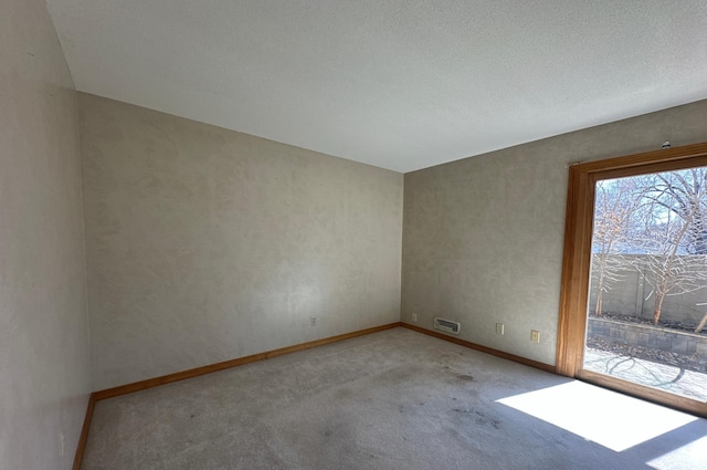 carpeted empty room with baseboards and visible vents