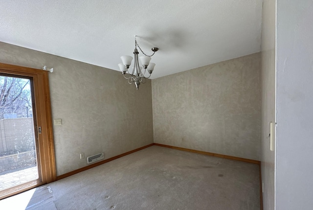 unfurnished dining area with carpet, visible vents, baseboards, and an inviting chandelier