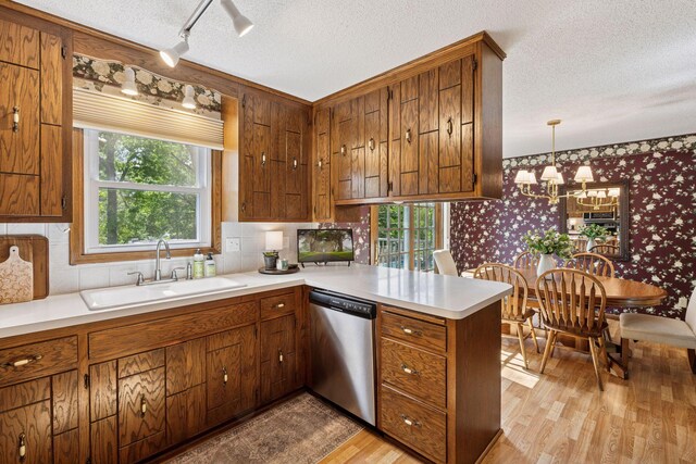 14704 Glendale Ave SE, Prior Lake, MN 55372 - kitchen with dishwasher, wallpapered walls, a sink, plenty of natural light, and a peninsula