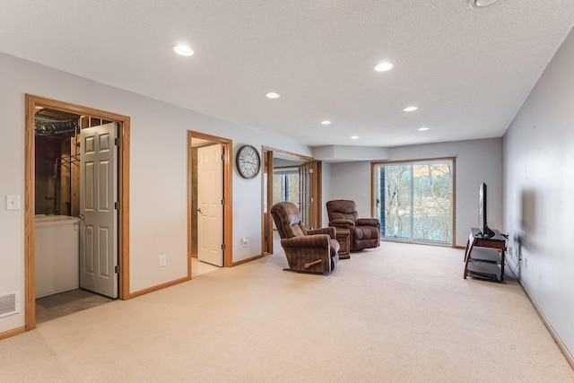 sitting room with carpet floors, baseboards, recessed lighting, and visible vents