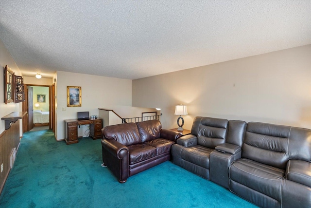 carpeted living room featuring a textured ceiling