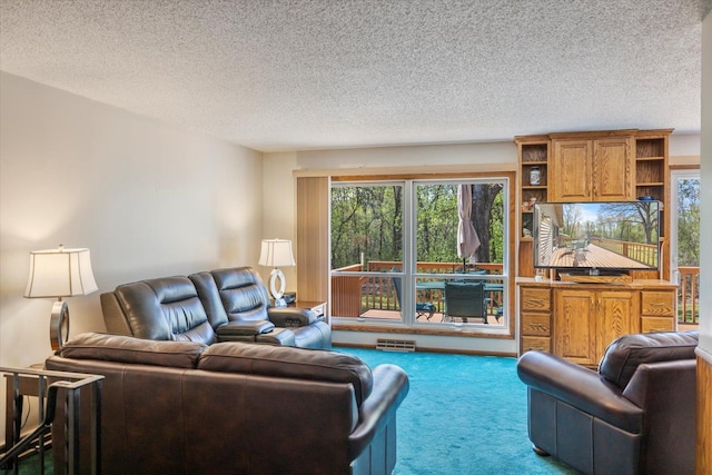living room featuring carpet, healthy amount of natural light, and a textured ceiling