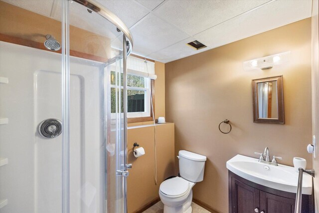 bathroom with a shower stall, toilet, and vanity
