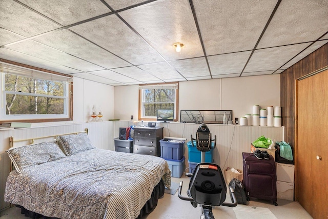 bedroom featuring wood walls