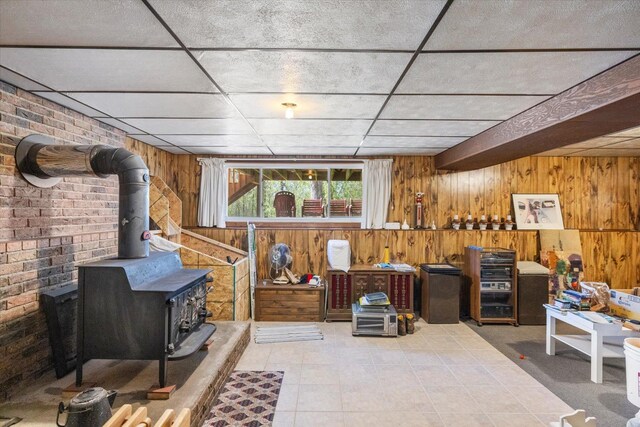 below grade area with wood walls and a wood stove