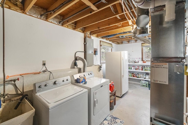 clothes washing area with independent washer and dryer, electric panel, and heating unit