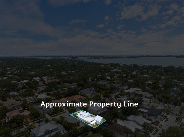 aerial overview of property's location with property boundaries highlighted and a large body of water