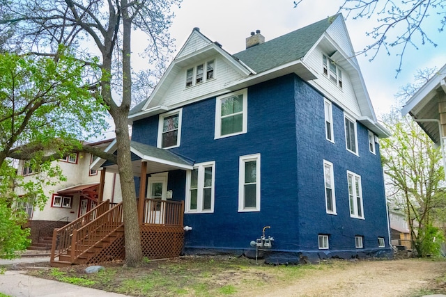 1023 17th Ave SE, Minneapolis, MN 55414 - view of front of home featuring a chimney and roof with shingles