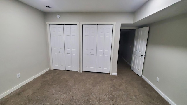 1023 17th Ave SE, Minneapolis, MN 55414 - unfurnished bedroom with baseboards, carpet, and multiple closets