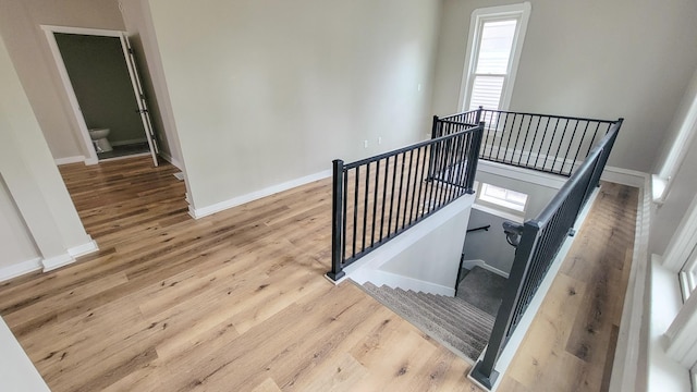1023 17th Ave SE, Minneapolis, MN 55414 - staircase with baseboards and wood finished floors