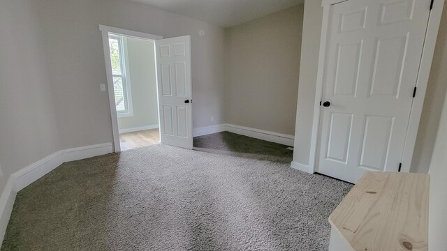 1023 17th Ave SE, Minneapolis, MN 55414 - unfurnished bedroom with carpet flooring and baseboards