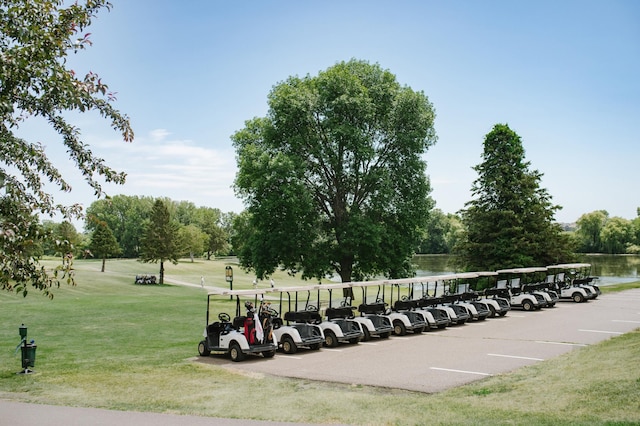 view of community featuring uncovered parking and a lawn