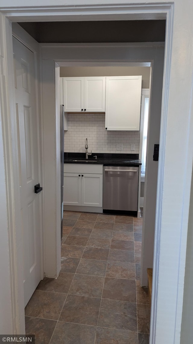 3454 Newton Ave N, Minneapolis, MN 55412 - kitchen featuring stainless steel dishwasher, a sink, white cabinetry, and dark countertops