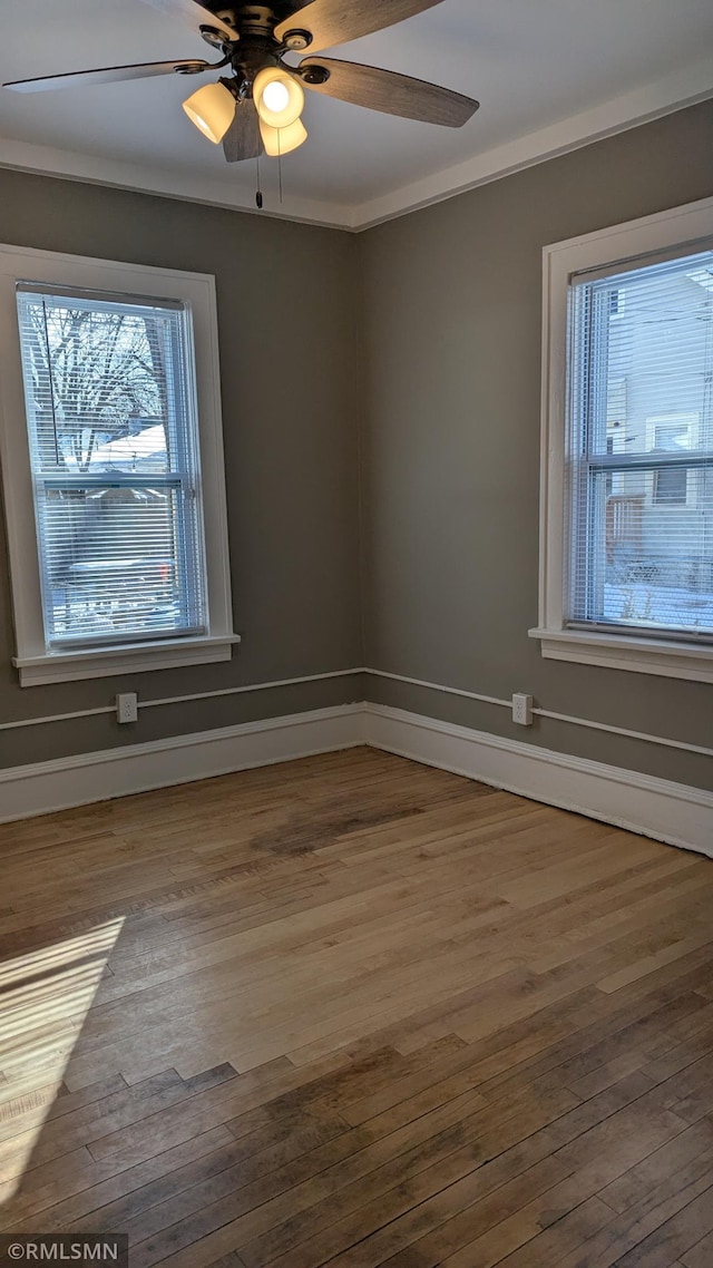 3454 Newton Ave N, Minneapolis, MN 55412 - unfurnished room with wood finished floors, ceiling fan, and baseboards