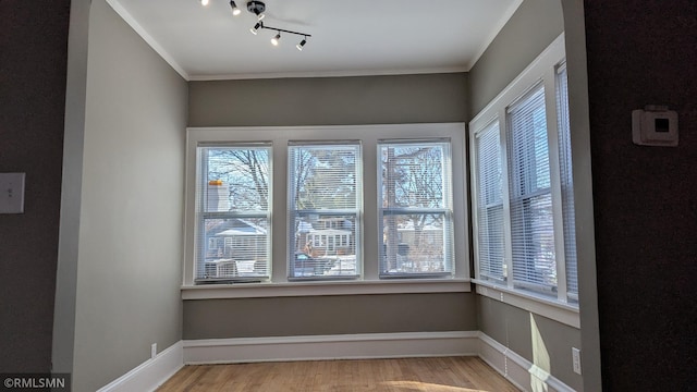 3454 Newton Ave N, Minneapolis, MN 55412 - unfurnished dining area with light wood finished floors, baseboards, and ornamental molding