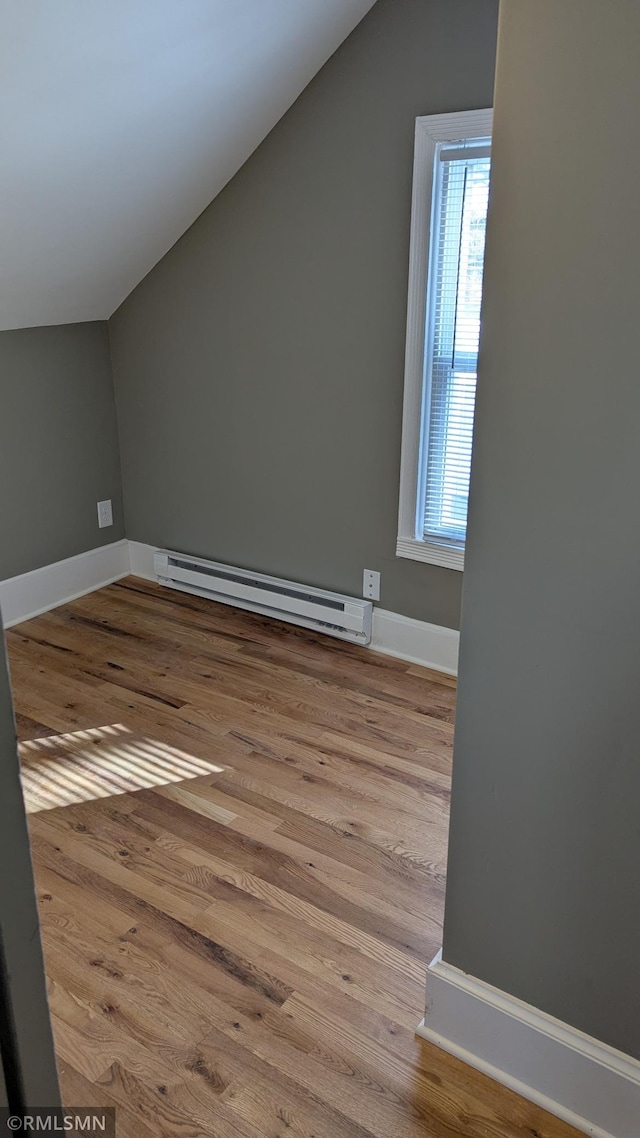 3454 Newton Ave N, Minneapolis, MN 55412 - additional living space featuring baseboard heating, vaulted ceiling, wood finished floors, and baseboards