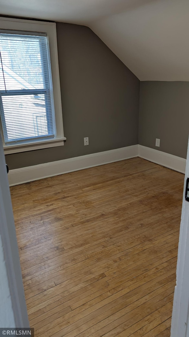 3454 Newton Ave N, Minneapolis, MN 55412 - additional living space with wood finished floors, lofted ceiling, and baseboards