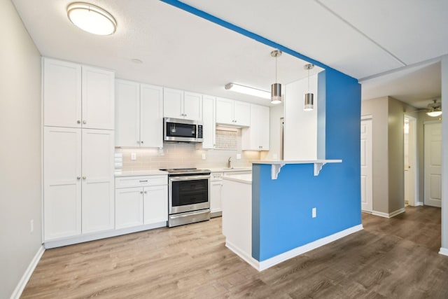 329 Geneva Ave N Unit 212, Oakdale, MN 55128 - kitchen with light wood-style flooring, white cabinets, and stainless steel appliances