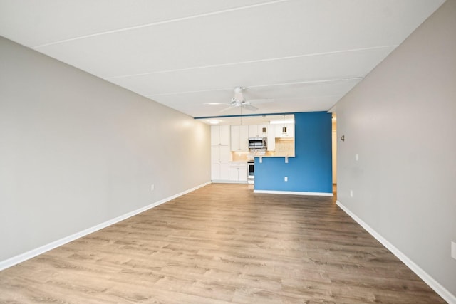 329 Geneva Ave N Unit 212, Oakdale, MN 55128 - unfurnished living room featuring light wood-style flooring, ceiling fan, and baseboards