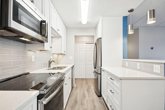 329 Geneva Ave N Unit 212, Oakdale, MN 55128 - kitchen with a sink, tasteful backsplash, appliances with stainless steel finishes, and light wood-style floors