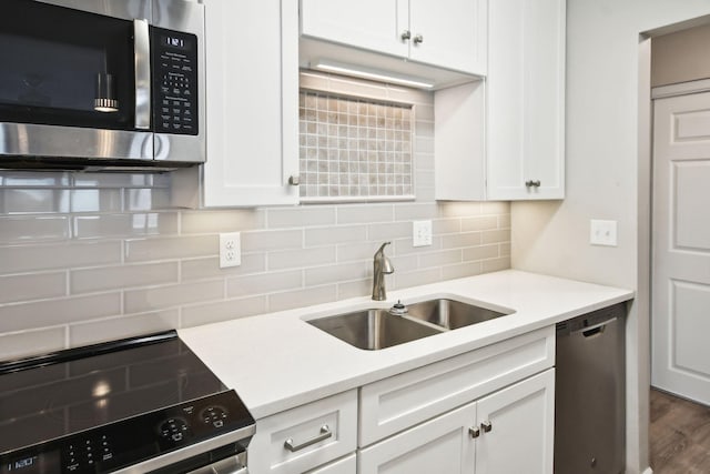 329 Geneva Ave N Unit 212, Oakdale, MN 55128 - kitchen with decorative backsplash, a sink, white cabinetry, and stainless steel appliances
