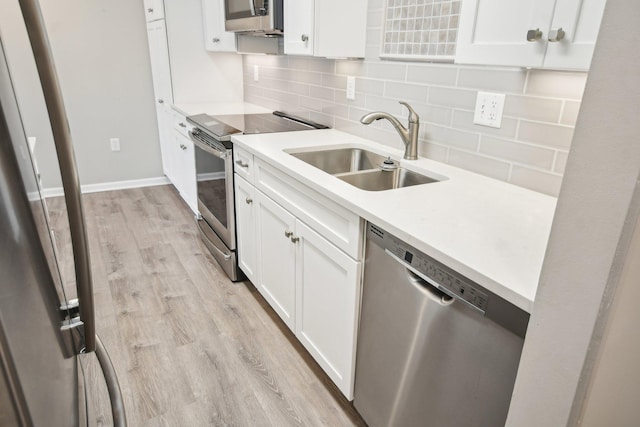 329 Geneva Ave N Unit 212, Oakdale, MN 55128 - kitchen with light wood-style flooring, white cabinets, appliances with stainless steel finishes, a sink, and backsplash