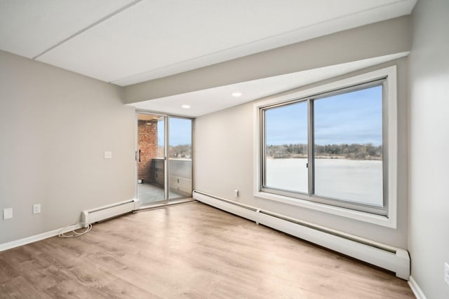 329 Geneva Ave N Unit 212, Oakdale, MN 55128 - interior space featuring light wood-style flooring, access to outside, a baseboard heating unit, and multiple windows