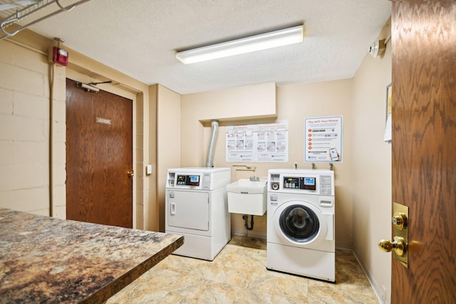 329 Geneva Ave N Unit 212, Oakdale, MN 55128 - shared laundry area with a textured ceiling, separate washer and dryer, and a sink